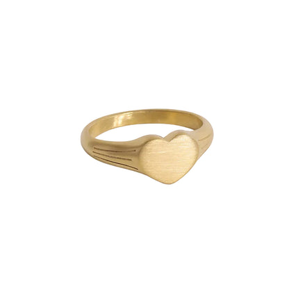 Gold ring with a heart design on a white background